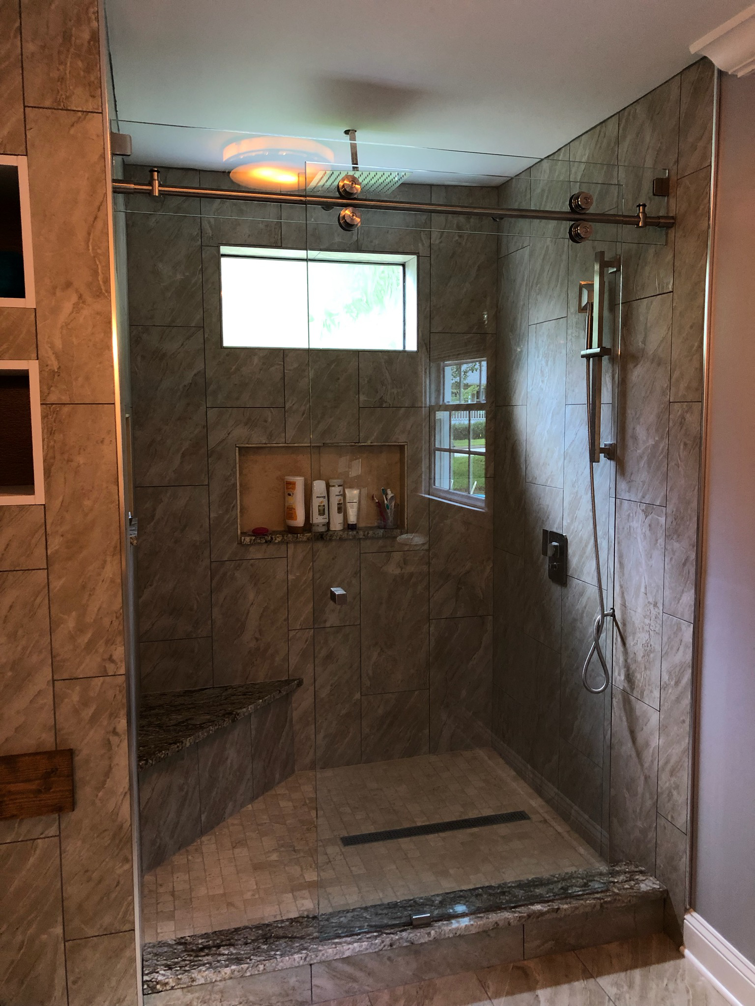 Sliding partition panel supported using glass transom.