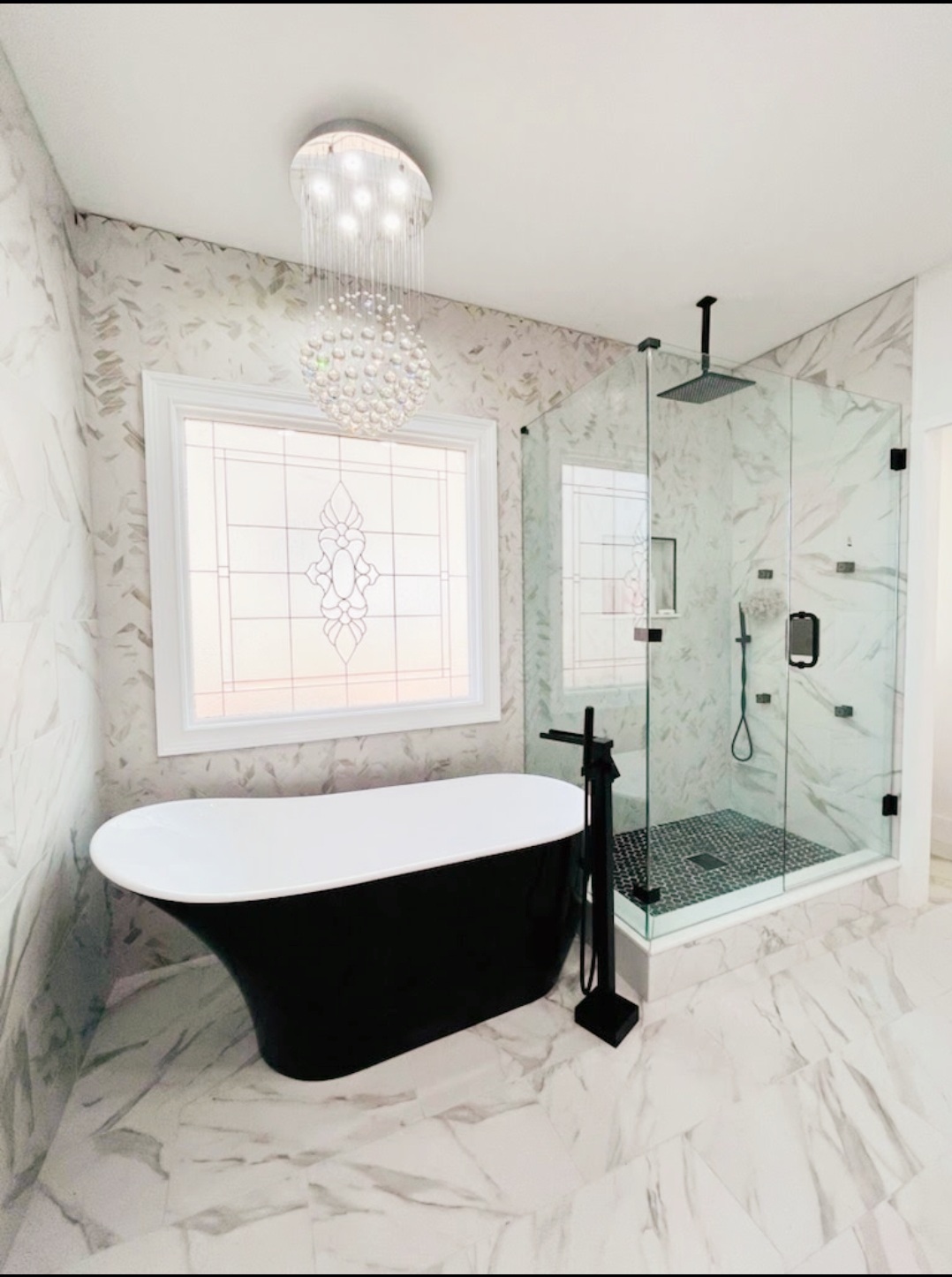 This bathroom is such a dream! We are loving the black freestanding tub against the black shower hardware.