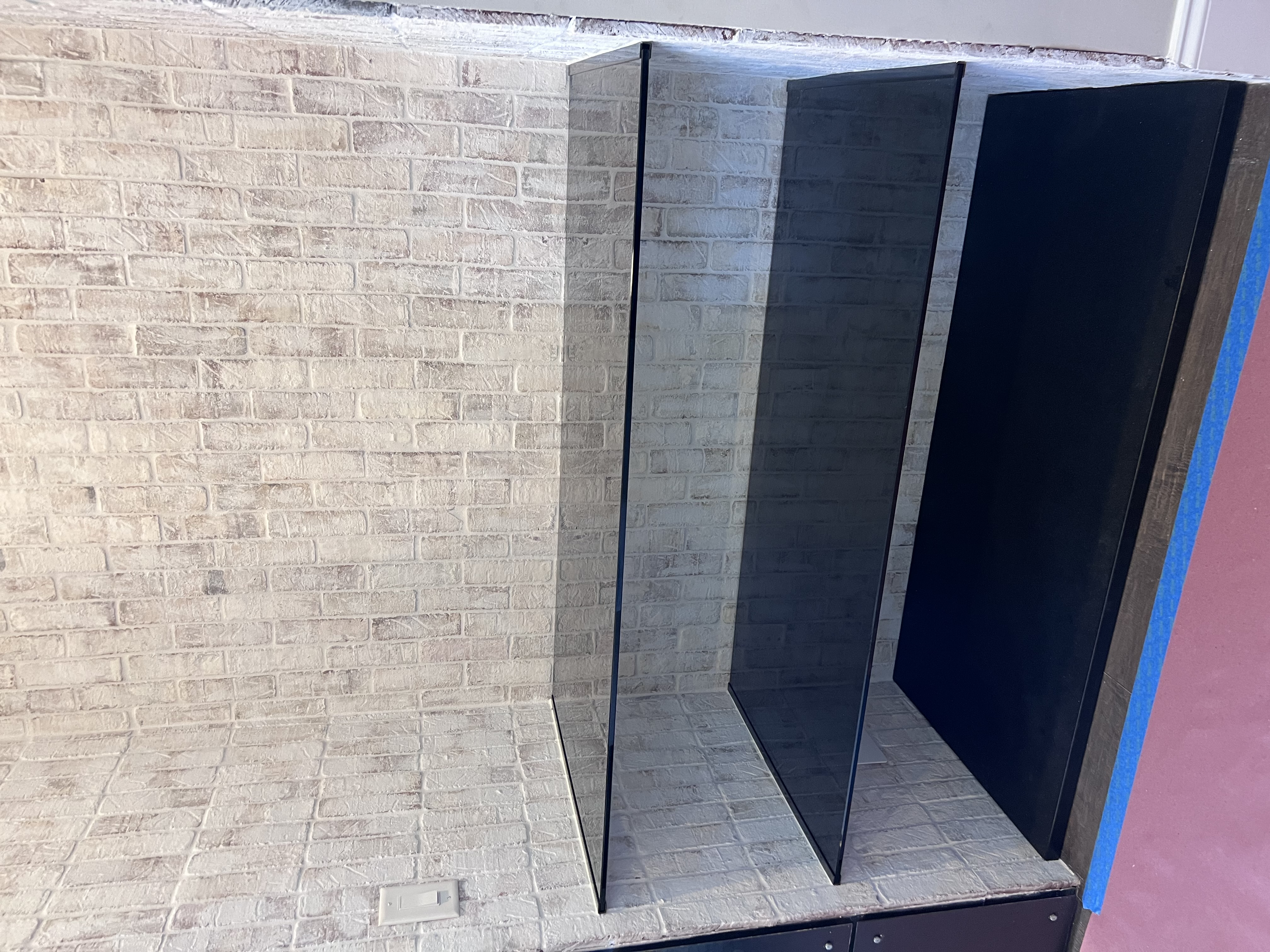 This special project features grey smoke glass television shelves with Gun Metal channel to mount them.