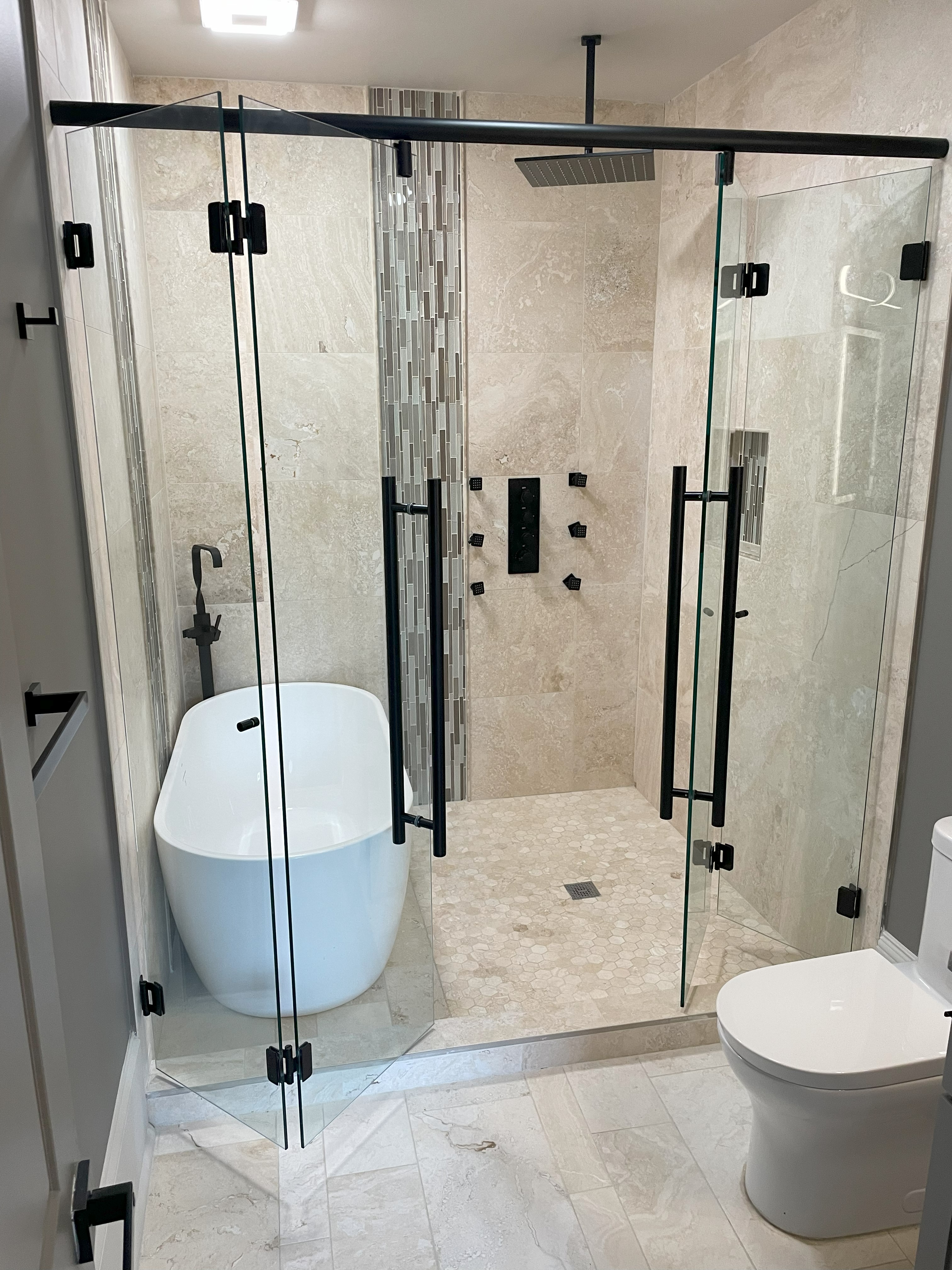 This shower features a double bi-fold accordion system which allows the user to open the left side away from the bathtub and the right side into the shower away from the toilet. This allows for the maximum possible opening for the homeowner!