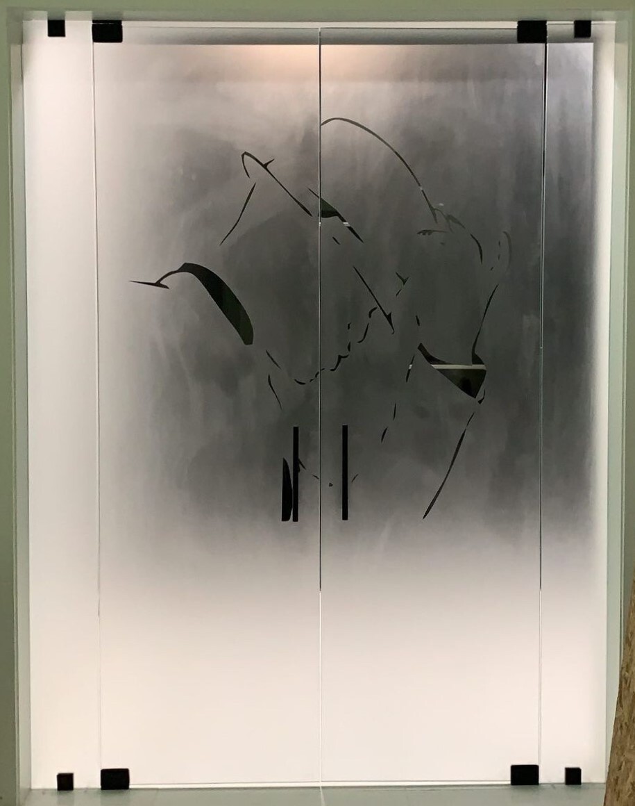 A reverse-etched closet door for Neyo with his logo on it!