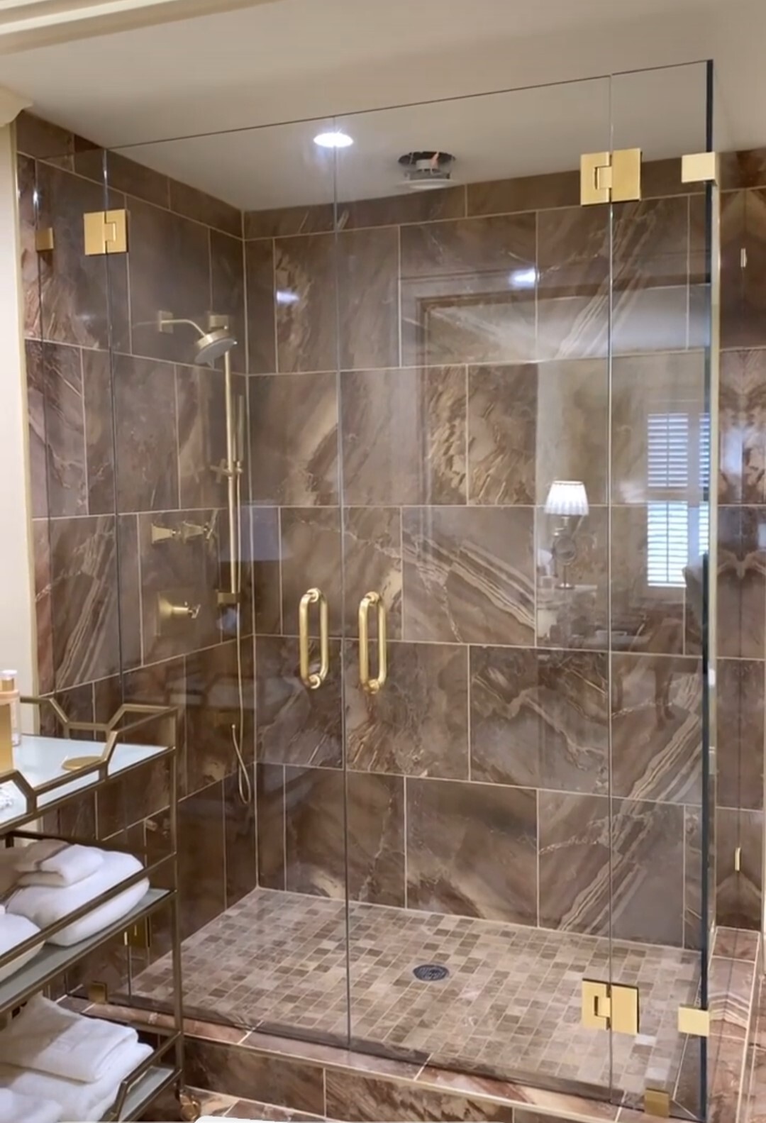 French doors in Satin Brass hardware to complement the gorgeous tile work in this shower door.