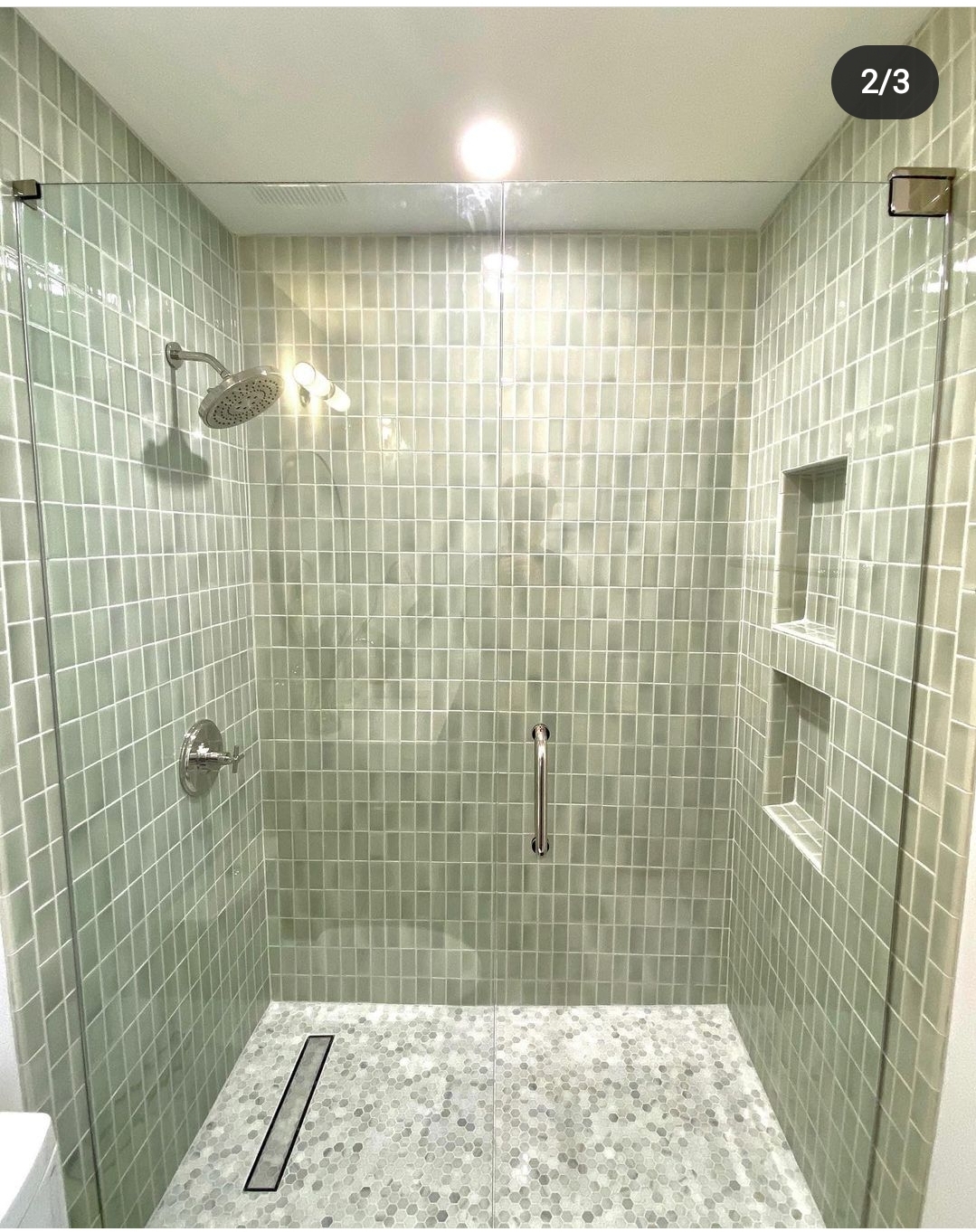 This shower features glass tile which requires a special type of hinge to alleviate pressure from the tiled wall! Gorgeous design and partnership with Nailed It Remodeling.