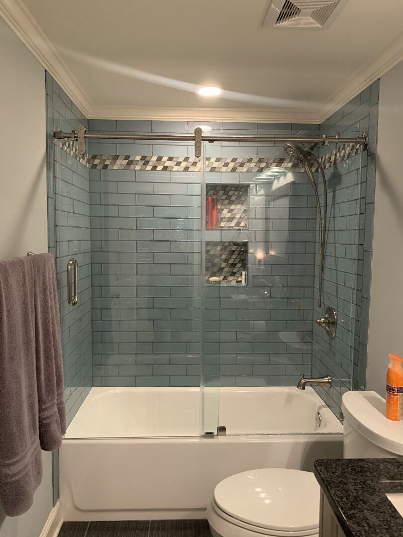 This PL80 series slider from Alumax provided us with a wonderful solution for a glass tile shower with a very narrow tub profile. The door of this sliding system slides beneath the bar to create a narrower profile on the tub, and the bar itself only requires one hole to be drilled on each side of the shower. This reduces the risk of breaking glass tiles during installation.